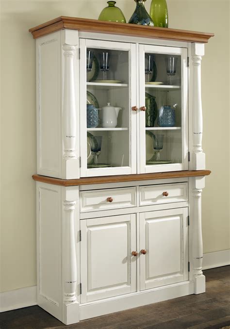 The hutch features two cabinets with glass doors, two small shelves between them, and a large space between the bottom of the shelves and the top of the. Home Styles Monarch Buffet and Hutch