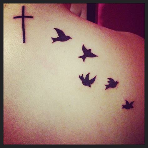 Cross And Bird Tattoo Symbolizes Freedom From The Restraint Of
