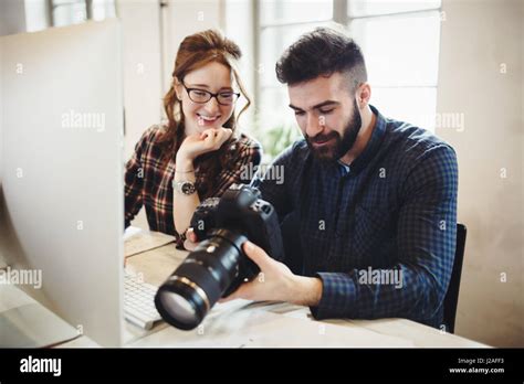 Company Photo Editor And Photographer Working Together In Office Stock