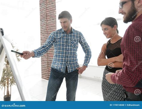 Handsome Man Is Pointing To The Whiteboard In Office Stock Photo