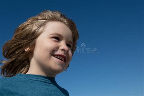 Kids Head On Blue Sky With Copy Space Close Up Close Up Head Shot Of