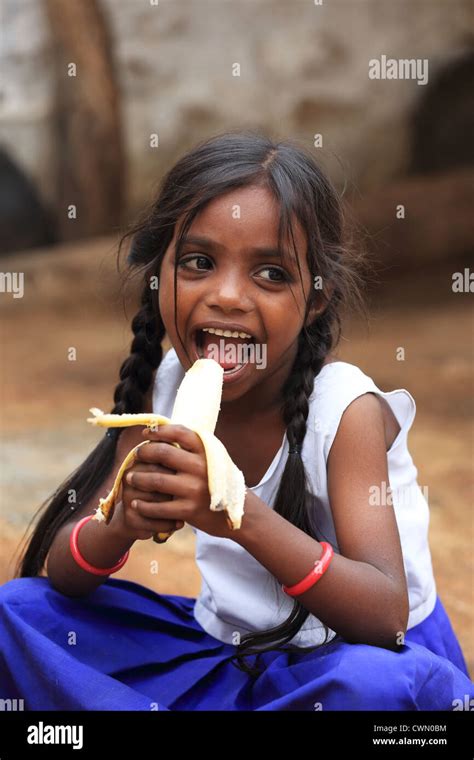 Young Indian Rural Girl Eating A Banana Andhra Pradesh South India