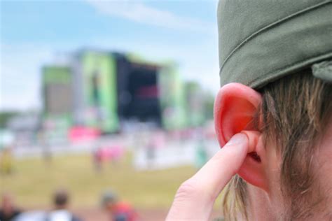 Choose the right ear plugs for your needs and protect your hearing! Earplugs At A Music Festival Stock Photo - Download Image Now - iStock