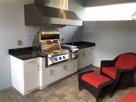 Wondering where to place your kitchen sink? Outdoor kitchen with massive hood, sink, burners, barbque ...