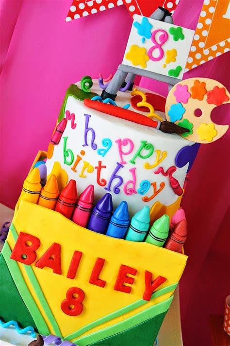 A Colorful Birthday Cake With Crayons On It