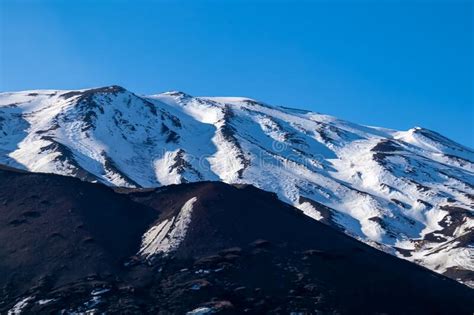 Etna Black Lava Crater With Vie On Snow Covered Volcano Mount Etna In