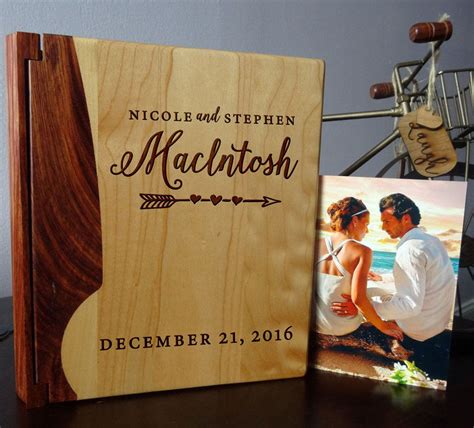 A Wooden Photo Frame With An Image Of A Bride And Groom On It Next To A Personalized Wedding Album