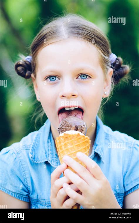 Smiling Little Girl Eating Ice Cream Stock Photo Alamy