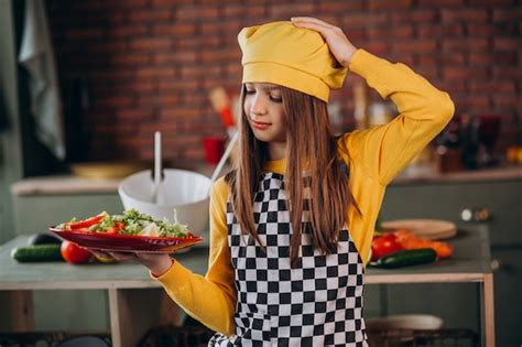 Free Photo Young Teen Girl Preparing Salad For Breakfast At The Kitchen