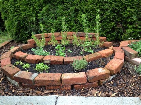 Gardens today ultimately serve an aesthetic purpose. brick planter, brick garden bed, herb garden, rosemary ...