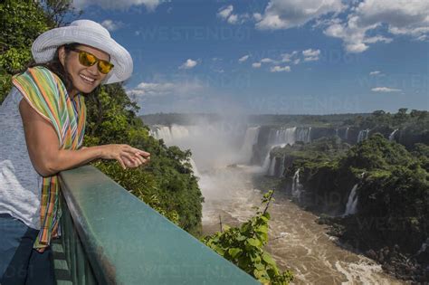 Woman Overlooking The Iguacu Waterfalls In Brazil Stock Photo