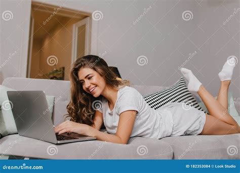 Lovely Brunette Girl In White Socks Using Laptop With Charming Smile