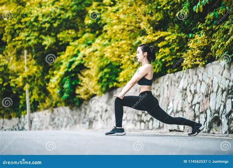Asian Fitness Woman Runner Stretching Legs Before Run Stock Image