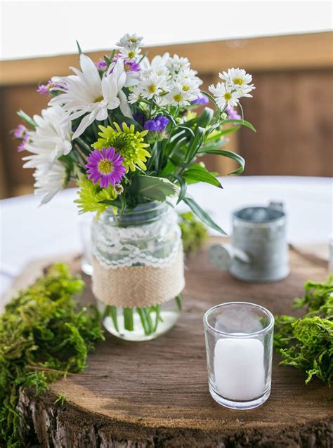 Daisy And Aster Centerpiece In Mason Jar On Wooden Slab Centerpieces