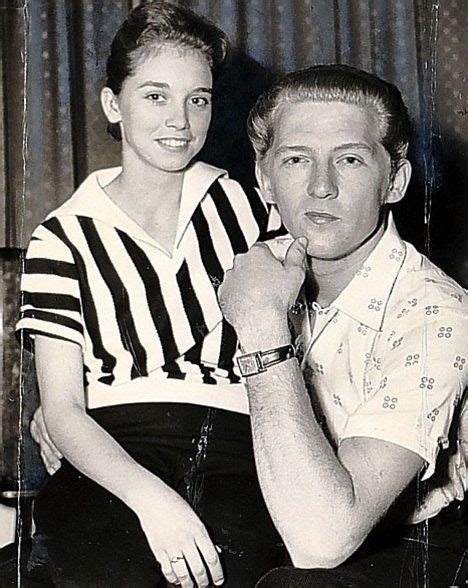 An Old Black And White Photo Of A Man Sitting Next To A Woman On A Chair