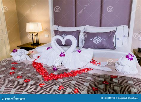 Two Swans Made From Towels Are Kissing On Honeymoon White Bed Stock