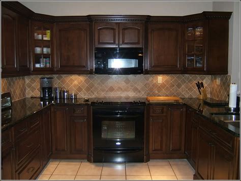 It is an essential element to your kitchen's style when doing a kitchen remodel. Cream Colored Kitchen Cabinets With Black Appliances ...