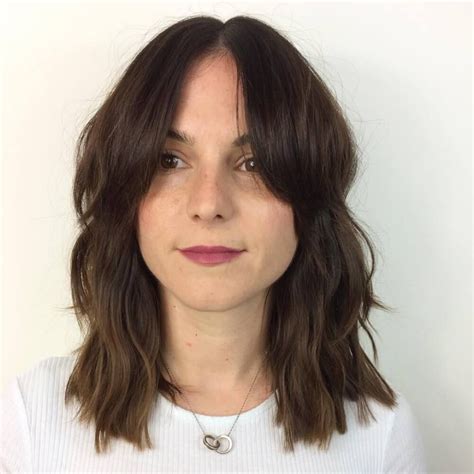 A long bob with curtain bangs gives a dreamy seventies vibe. Pin on Medium Layered Haircuts