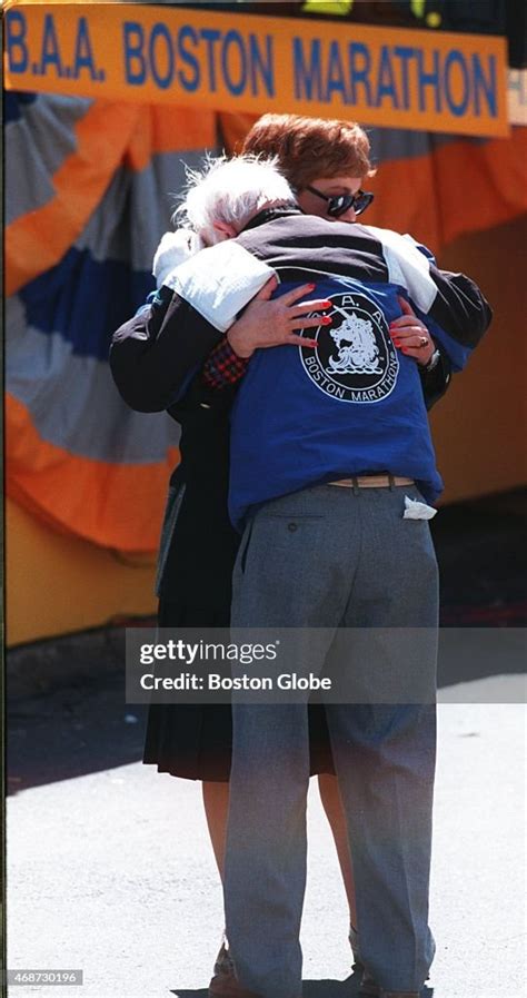 Grand Marshal Johnny Kelley Embraces A Woman During The 1995 Boston