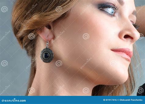 Beautiful Model Brunette With Long Hair And Jewelry Earrings Stock