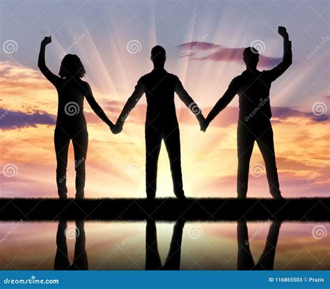 Silhouette Of A Group Of Happy People Of Three People Holding Hands