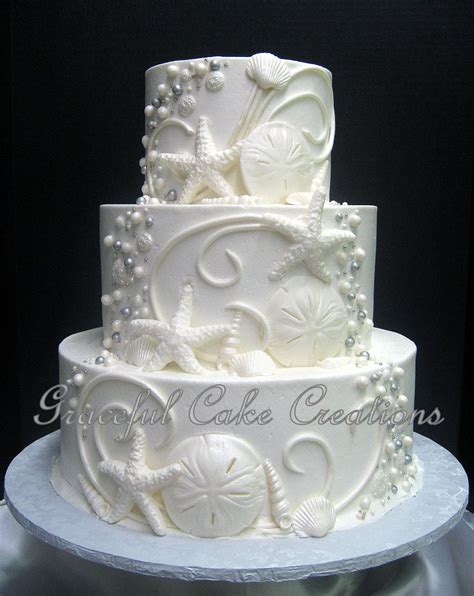 This cake is a stunner. Elegant Beach Themed White Butter Cream Wedding Cake with ...