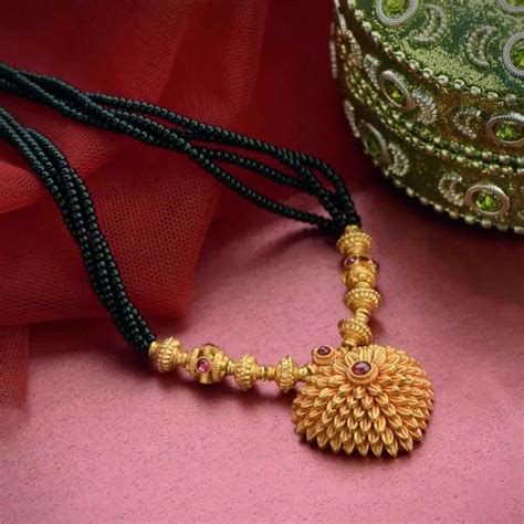 Moon shaped diamond ring gives a adorable look for this mangalsutra. Gold Mangalsutra Designs From Waman Hari Pethe Jewellers