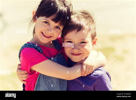 Two Happy Kids Hugging Outdoors Stock Photo Alamy