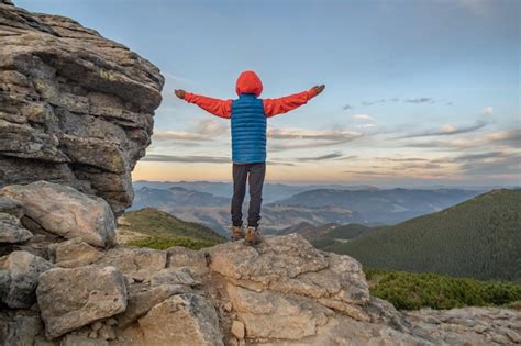 Premium Photo Young Child Boy Hiker Standing With Raised Hands In