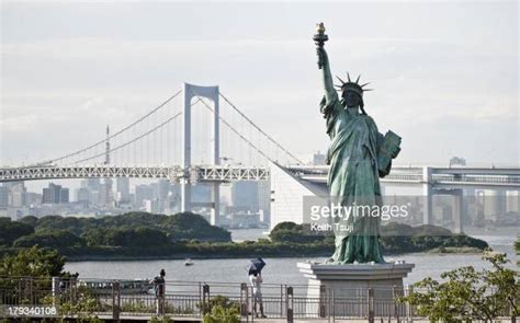 A Replica Statue Of Liberty Stands In Odaiba Along With Tokyo Rainbow