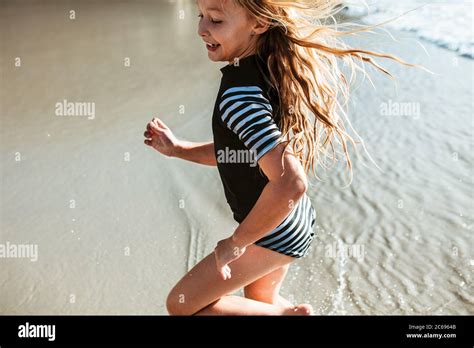 Cute Girl Running In Water At The Beach Small Girl Having Fun On