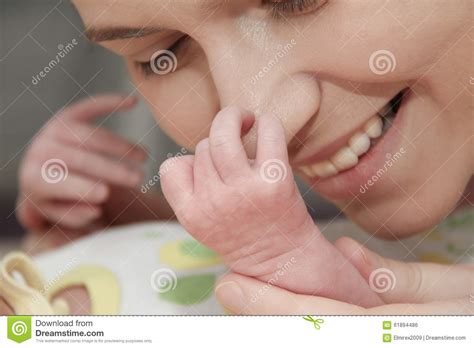 Mother And Her Newborn Baby Parent Holding Newborns Hands Stock Photo