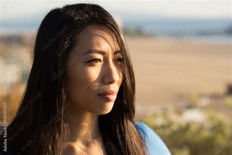 Young Asian Woman Looking Far Away Stock Photo Adobe Stock