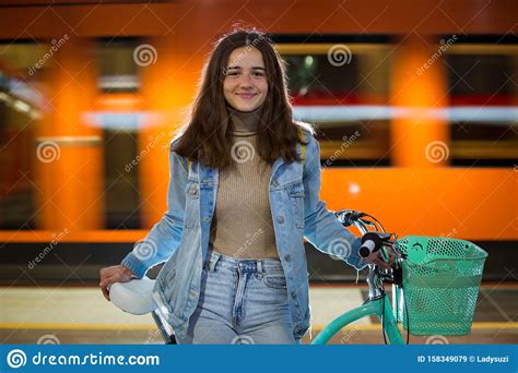 Teenager Girl In Jeans With Yellow Backpack And Bike Standing On Metro Station Stock Image