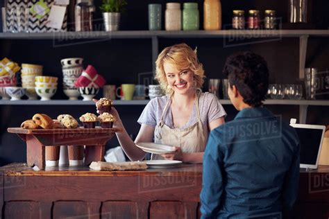 Staff Serving Customer In Busy Coffee Shop Stock Photo Dissolve