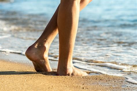 Premium Photo Close Up Of Woman Feet Walking Barefoot On Sand Leaving Footprints On Golden Beach