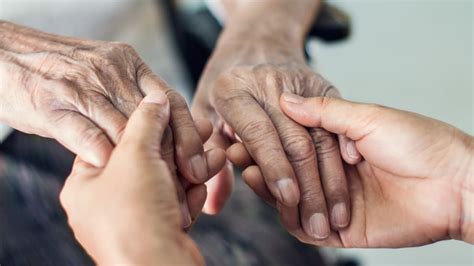 Close Up Hands Of Helping Hands Elderly Home Care Mother And Daughter