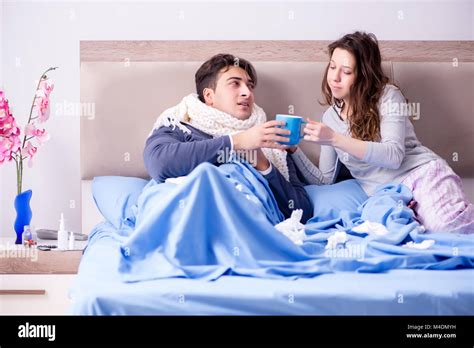 The Wife Caring For Sick Husband At Home In Bed Stock Photo Alamy