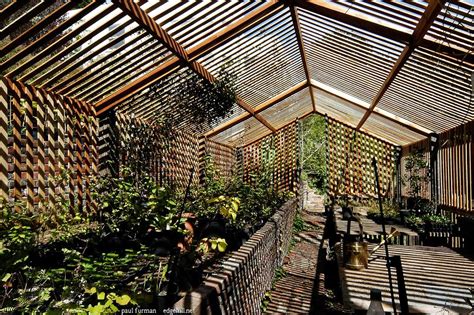 The Inside Of A Wooden Structure With Benches And Plants