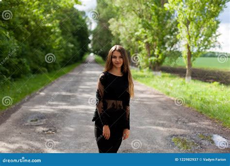 Steep Slender Ukrainian Woman On The Asphalt Old Road Stock Image