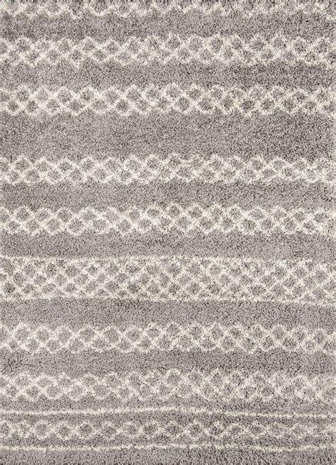 A Rug With Grey And White Stripes On It