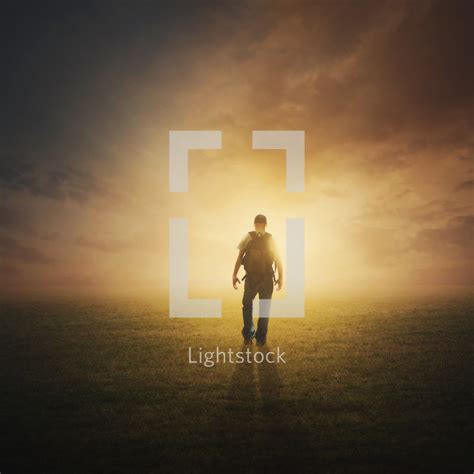 A Man Walking Into The Light — Photo — Lightstock