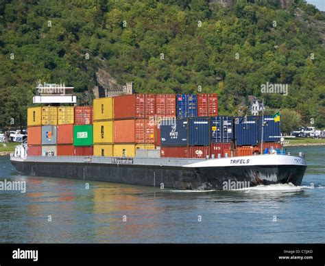 Large Barge Carrying Container Freight Sailing Up The River Rhine In