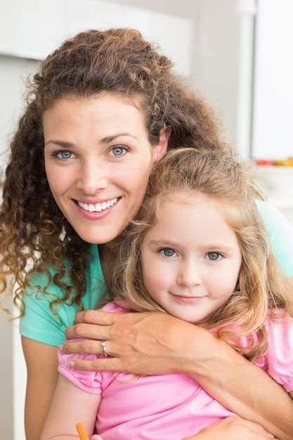 Premium Photo Smiling Mother And Daughter Cuddling