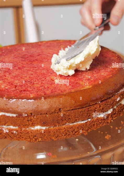 Spreading Frosting Over Top Of Cake Making Torte With Buttercream Filling And Grated Chocolate