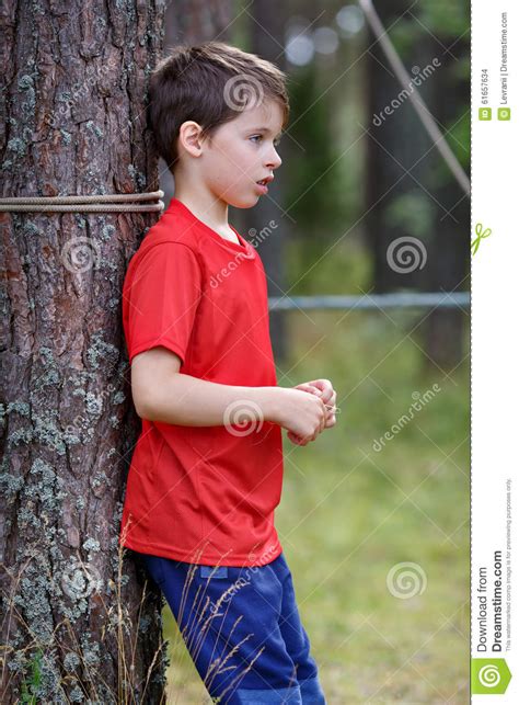 Like my meaty ornament hanging off of the tree? Sad Little Boy Standing Under The Tree Stock Photo - Image ...