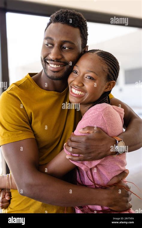 Happy African American Couple Hugging In Living Room Stock Photo Alamy