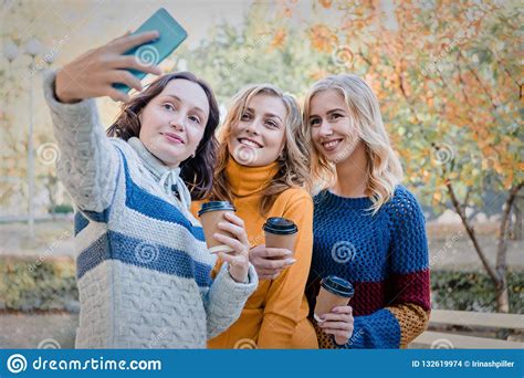 Cheerful Attractive Three Young Women Best Friends Having Fun Together Outside And Making Selfie