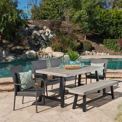 Slightly slanted metal legs complete its rustic design, providing an additional hint of elegance to your lawn, patio, or even in your home's. Anson Outdoor 6 Piece Stacking Wicker Dining Set with ...