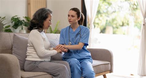 Happy Patient Is Holding Caregiver For A Hand While Spending Time